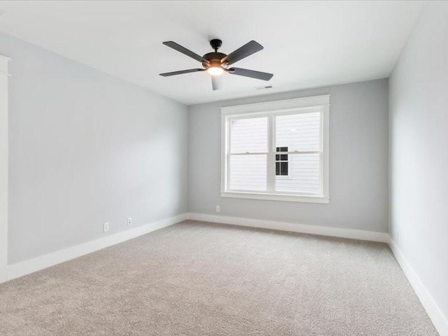 carpeted spare room with ceiling fan