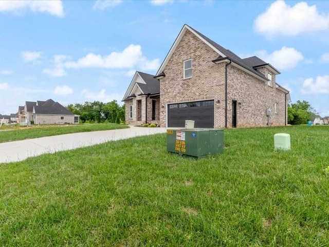 view of side of property featuring a garage and a yard