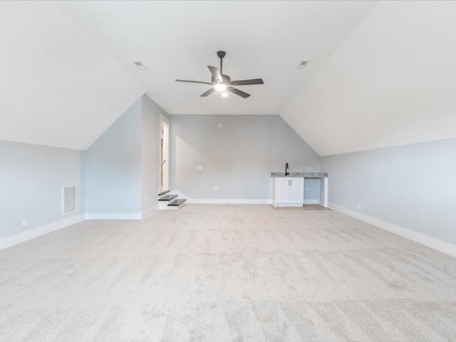 bonus room with ceiling fan, light carpet, and lofted ceiling