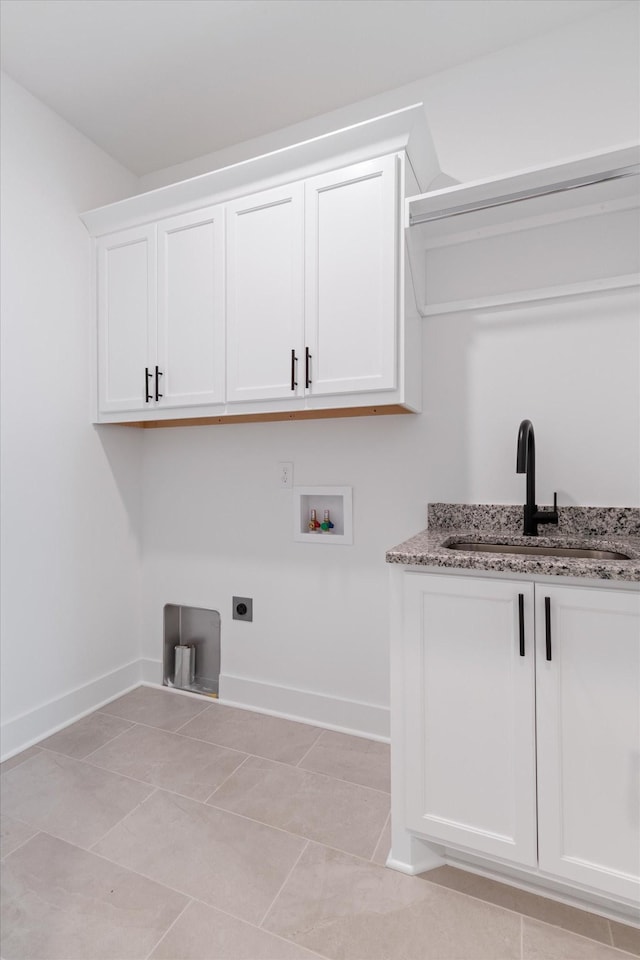 washroom with sink, cabinets, washer hookup, electric dryer hookup, and light tile patterned flooring