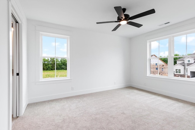 carpeted empty room featuring ceiling fan