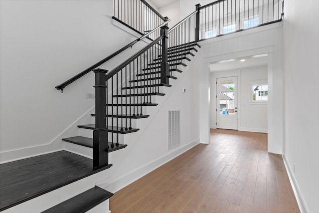 interior space with wood-type flooring and a high ceiling