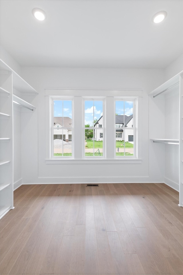 spacious closet featuring light hardwood / wood-style floors