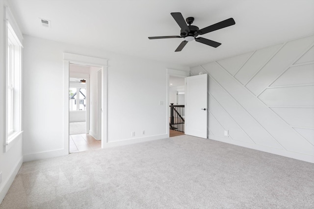 carpeted empty room with ceiling fan