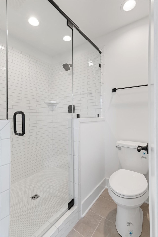 bathroom with tile patterned floors, toilet, and walk in shower