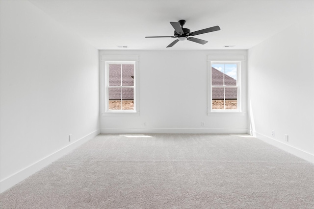 carpeted spare room with ceiling fan