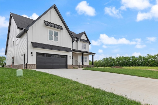 modern farmhouse style home featuring a garage and a front lawn