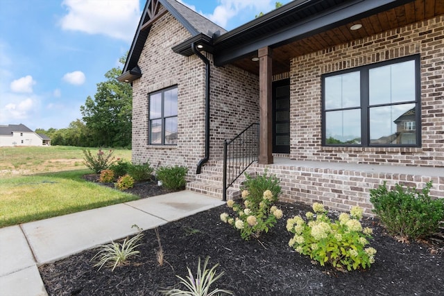 doorway to property with a lawn