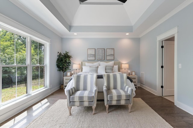 bedroom featuring dark hardwood / wood-style flooring, a raised ceiling, and vaulted ceiling