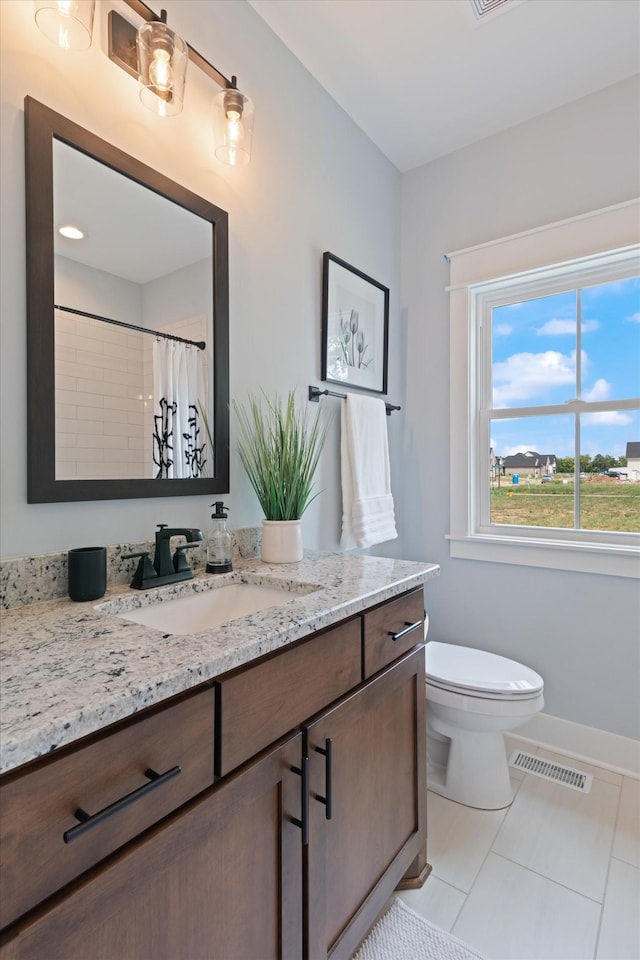 bathroom featuring a shower with shower curtain, tile patterned floors, vanity, and toilet