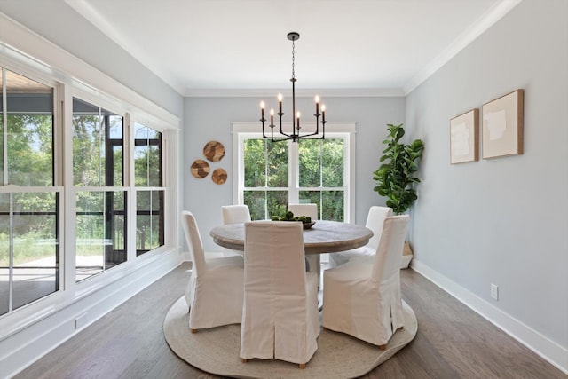 dining area with dark hardwood / wood-style floors, crown molding, and a chandelier