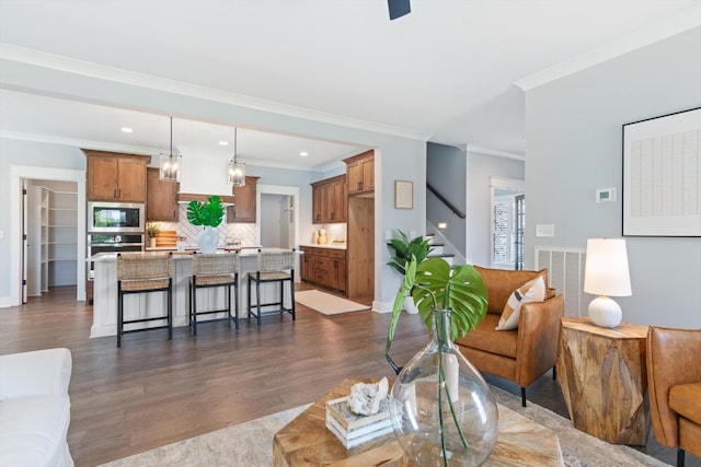 living room featuring dark hardwood / wood-style flooring and crown molding