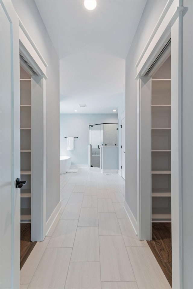 corridor featuring light tile patterned floors