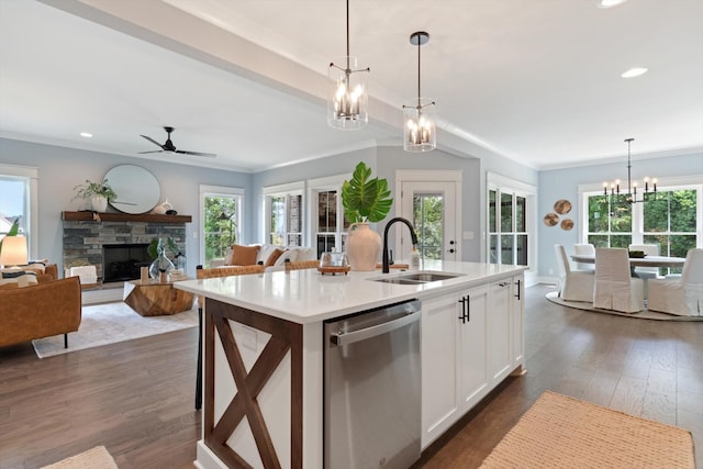 kitchen featuring white cabinets, sink, decorative light fixtures, a center island with sink, and dishwasher