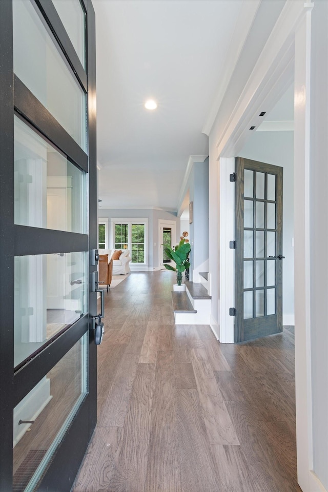 hall featuring hardwood / wood-style floors and crown molding