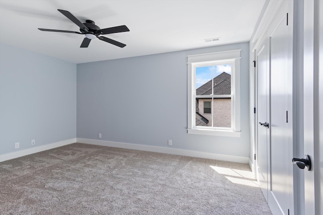 unfurnished room with light colored carpet and ceiling fan