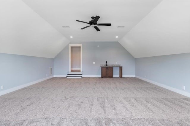 bonus room with ceiling fan, light colored carpet, and vaulted ceiling