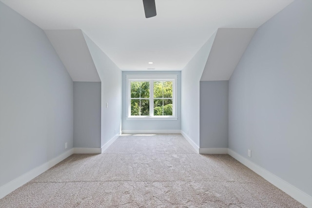 bonus room featuring light carpet and vaulted ceiling