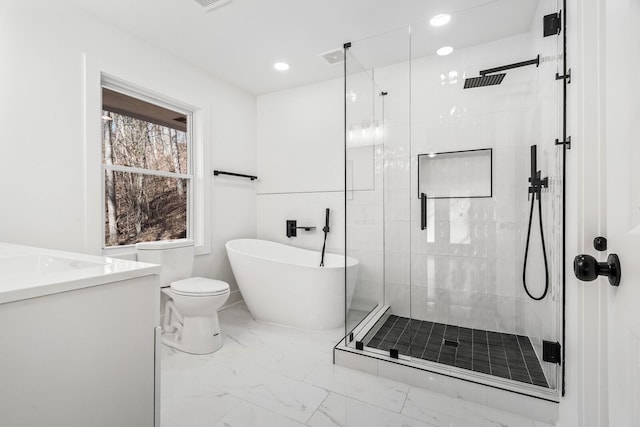 full bathroom featuring vanity, independent shower and bath, and toilet