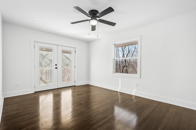 spare room with ceiling fan, dark wood-type flooring, and french doors