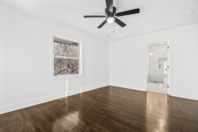 empty room featuring ceiling fan and dark wood-type flooring