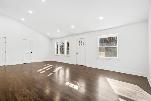 unfurnished living room featuring dark hardwood / wood-style floors and lofted ceiling