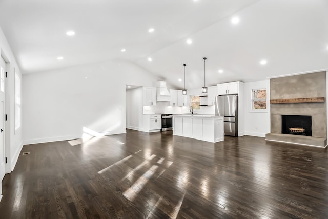 unfurnished living room with dark hardwood / wood-style floors, lofted ceiling, and sink