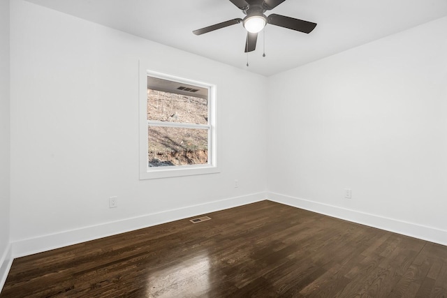 spare room with ceiling fan and dark hardwood / wood-style floors