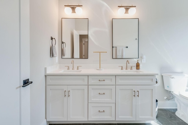 bathroom with tile patterned flooring, vanity, and toilet