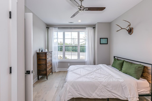 bedroom with ceiling fan and light wood-type flooring