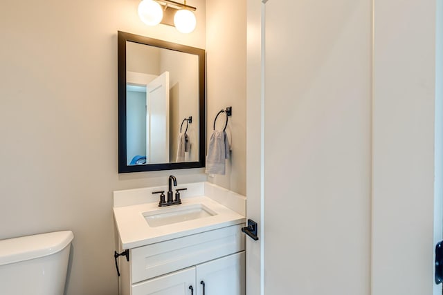 bathroom featuring vanity and toilet