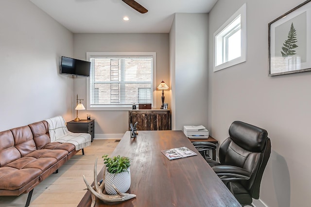 office area with light wood-type flooring and ceiling fan