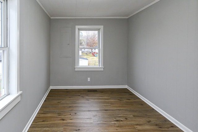 unfurnished room featuring dark wood-type flooring and ornamental molding