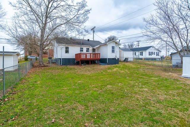 rear view of house featuring a deck and a lawn