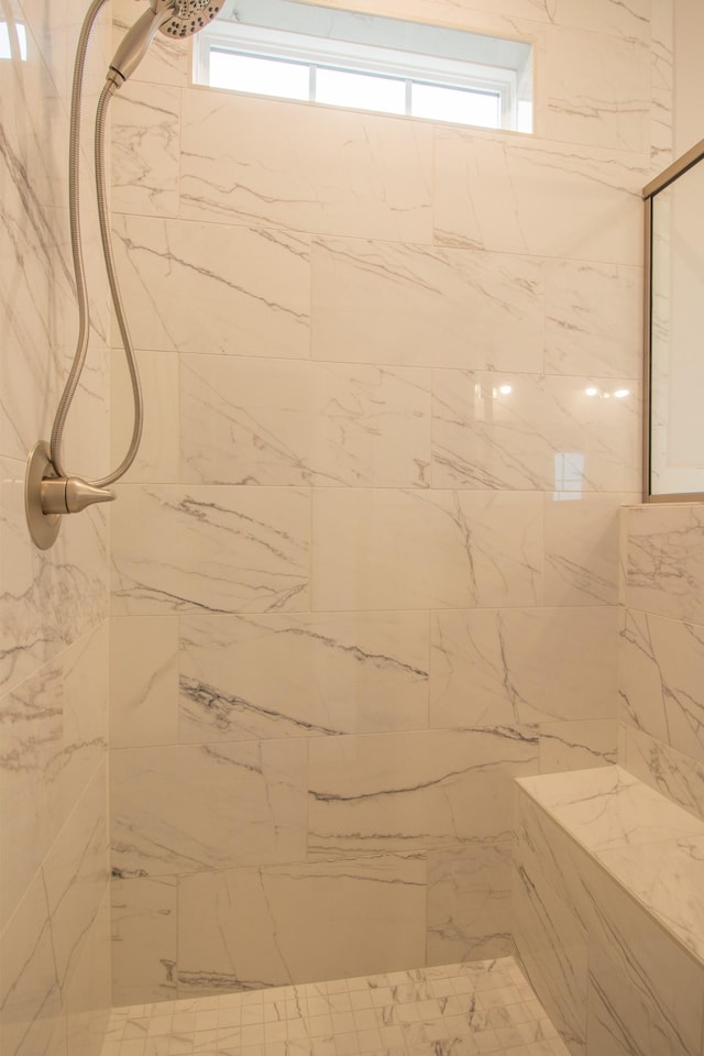 bathroom with tiled shower