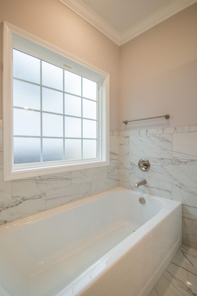 bathroom featuring crown molding and a bathing tub