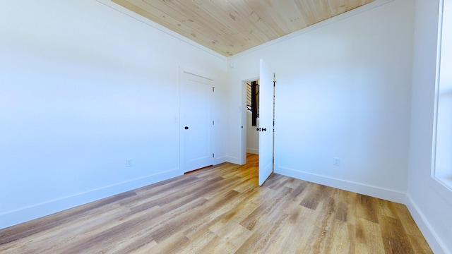 unfurnished room featuring wood ceiling, crown molding, and light hardwood / wood-style flooring