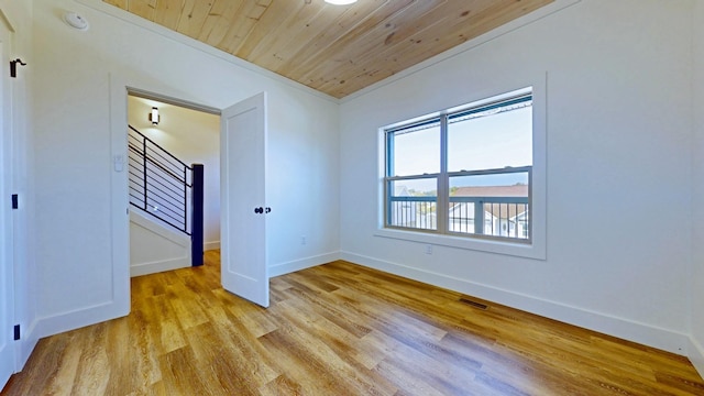 unfurnished bedroom with wood ceiling, light hardwood / wood-style flooring, and ornamental molding