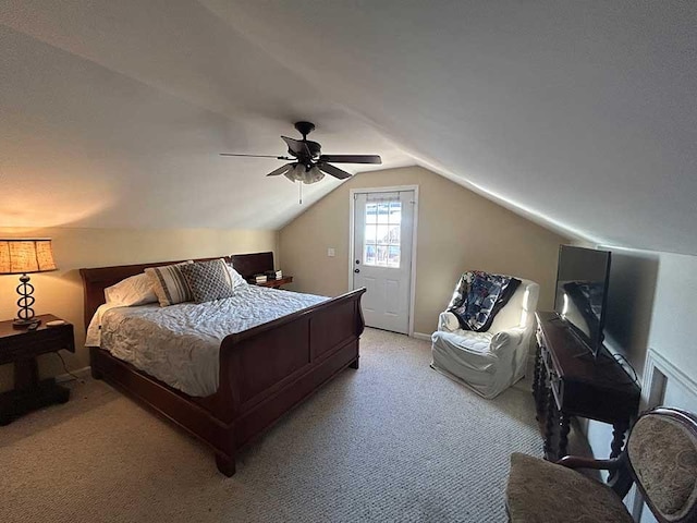 bedroom with lofted ceiling, ceiling fan, and light carpet