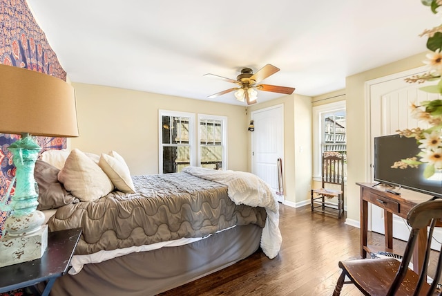 bedroom with ceiling fan, baseboards, and wood finished floors