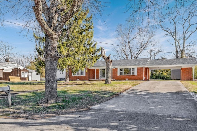 ranch-style house featuring a carport and a front lawn