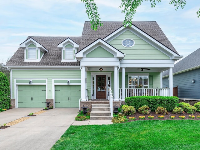 craftsman house featuring a front yard, a garage, and a porch