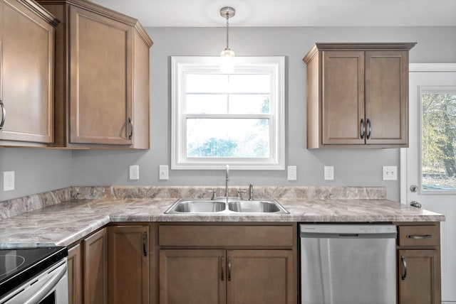 kitchen with sink, pendant lighting, and dishwasher