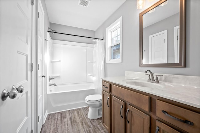 full bathroom featuring shower / tub combination, hardwood / wood-style floors, vanity, and toilet