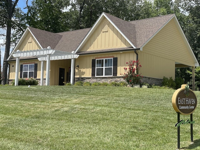 view of front of property with a front yard and a pergola