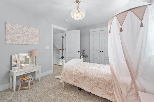 bedroom featuring a closet, a chandelier, and carpet