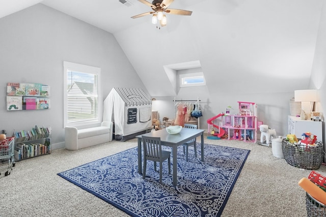 recreation room featuring carpet flooring, ceiling fan, vaulted ceiling, and a wealth of natural light