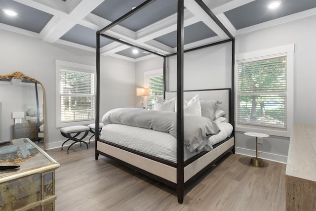 bedroom with ornamental molding, coffered ceiling, and hardwood / wood-style flooring