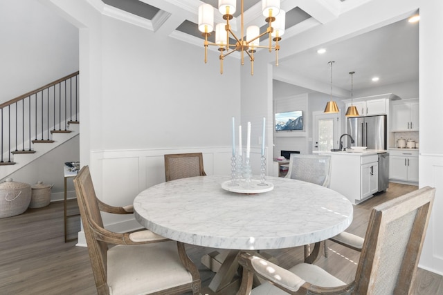 dining room with an inviting chandelier, coffered ceiling, dark hardwood / wood-style flooring, crown molding, and beam ceiling