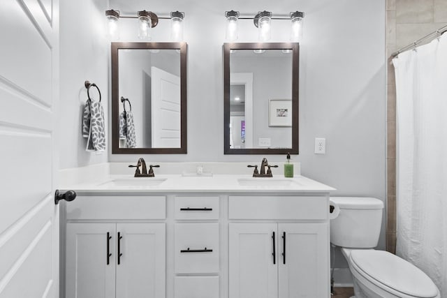 bathroom featuring walk in shower, vanity, and toilet